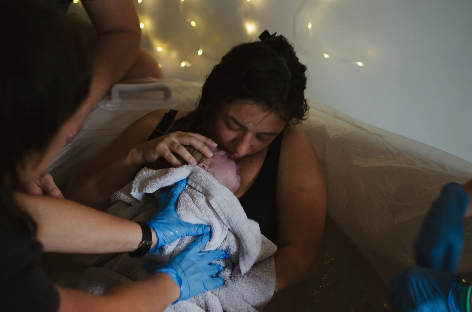 A parent holding their newborn just after birth